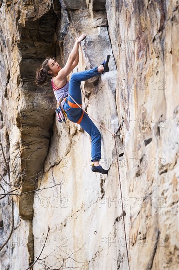 Teenage girl rock climbing