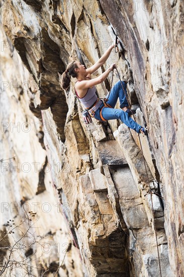 Teenage girl rock climbing