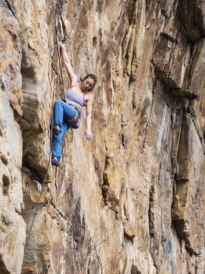 Teenage girl rock climbing