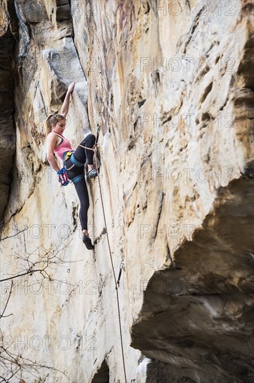 Teenage girl rock climbing
