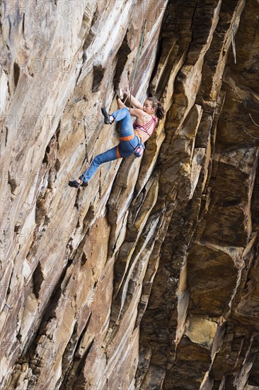 Teenage girl rock climbing