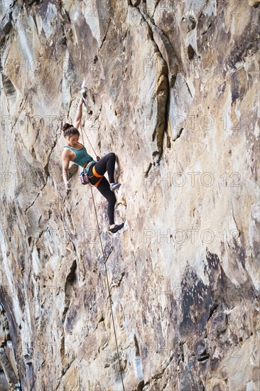 Teenage girl rock climbing