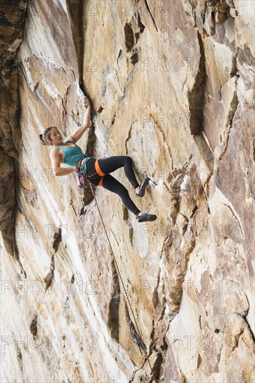 Teenage girl rock climbing