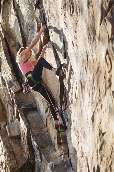 Teenage girl rock climbing