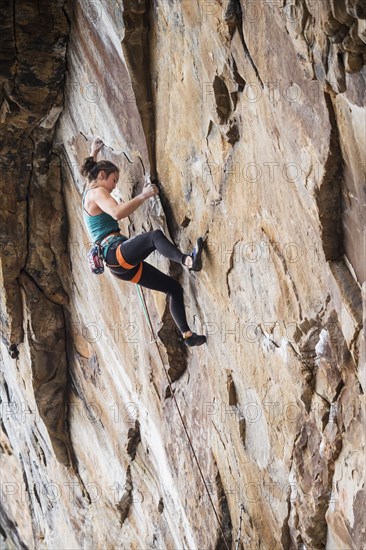 Teenage girl rock climbing