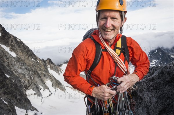 Mature man mountain climbing on Mount Stuart in North Cascade Mountains, Washington, USA