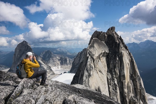 Man photographing mountain in Bugaboo Provincial Park, British Columbia, Canada