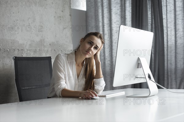 Frustrated businesswoman working at desktop computer
