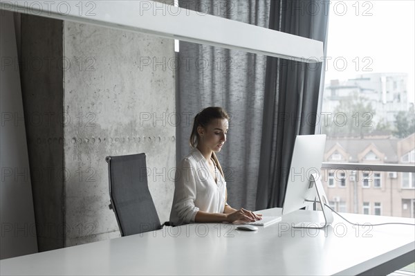 Young businesswoman working on desktop computer