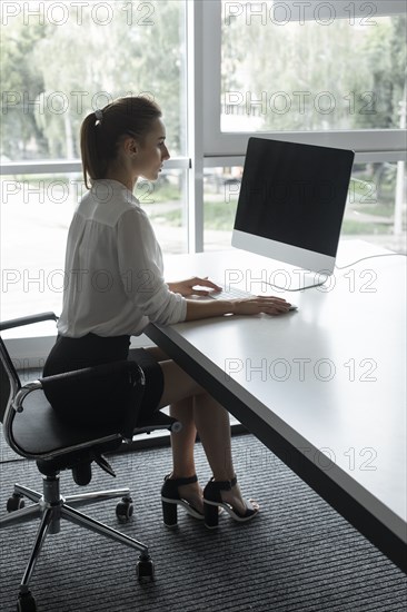 Young businesswoman working on desktop computer