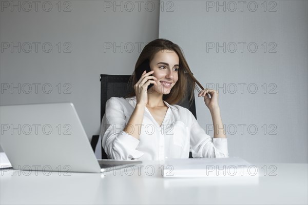 Smiling businesswoman on phone call