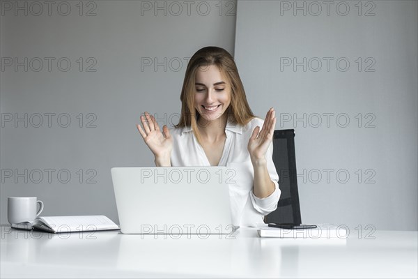 Smiling businesswoman working on laptop