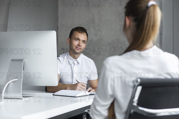 Businessman conducting job interview with young woman