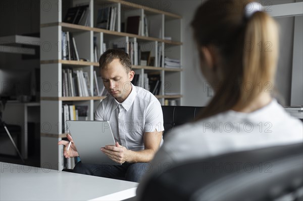 Businessman conducting job interview with young woman