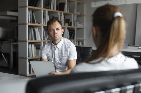 Businessman conducting job interview with young woman