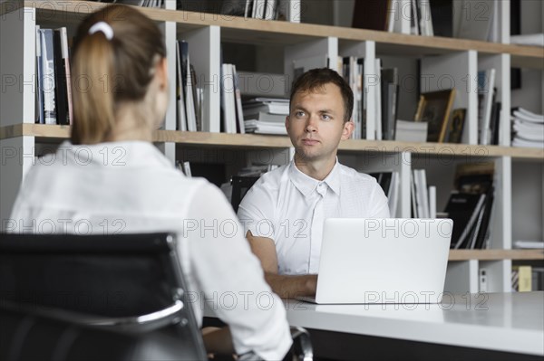 Businessman conducting job interview with young woman