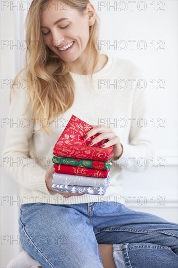 Smiling woman holding Christmas fabrics