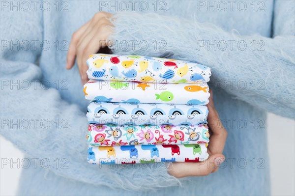 Hands of woman holding animal print fabrics