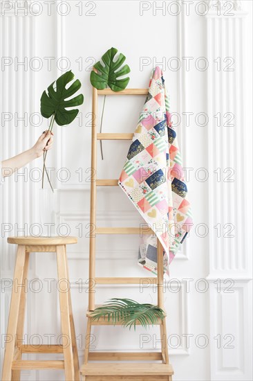 Fabric on rack with palm leaves