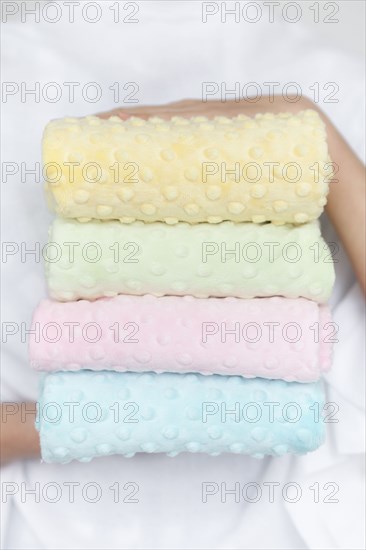 Hands of woman holding pastel color fabrics