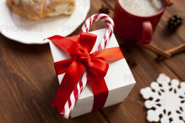 Christmas present with red ribbon and candy cane