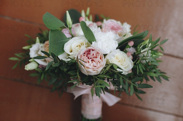 Wedding bouquet tied with pink ribbon