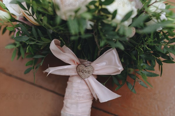 Wedding bouquet tied with pink ribbon