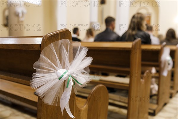 Tulle wedding decoration on pew