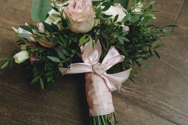 Wedding bouquet tied with pink ribbon