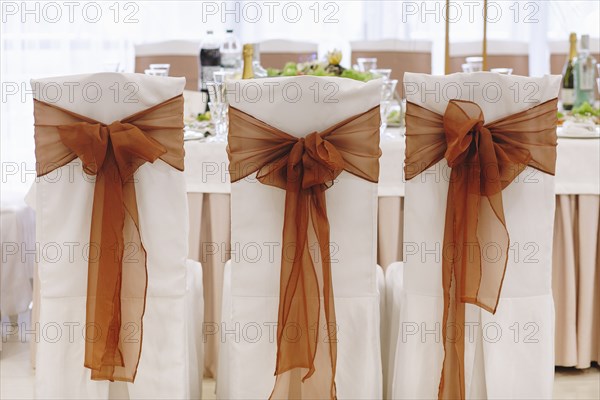 Ribbon tied to dining chairs at wedding