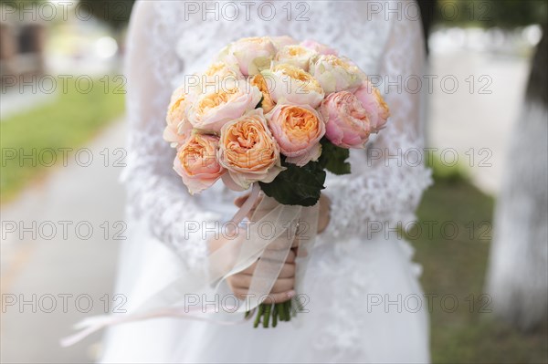 Hands of bride holding bouquet