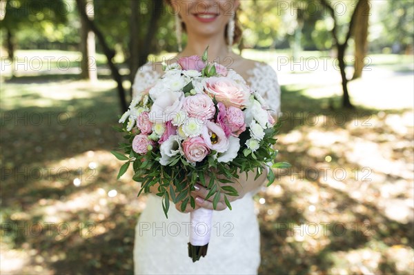 Hands of bride holding bouquet