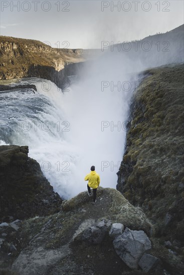 Hiker by Gullfoss waterfall in Iceland