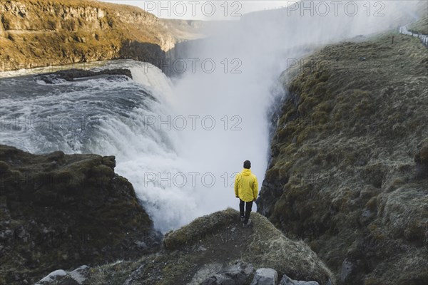 Hiker by Gullfoss waterfall in Iceland