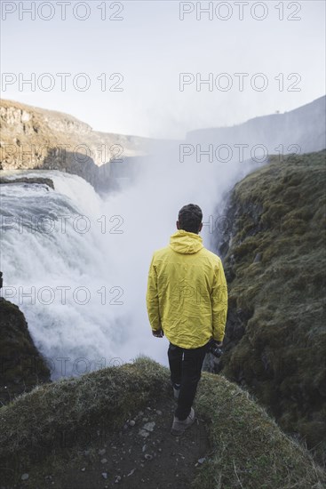 Hiker by Gullfoss waterfall in Iceland