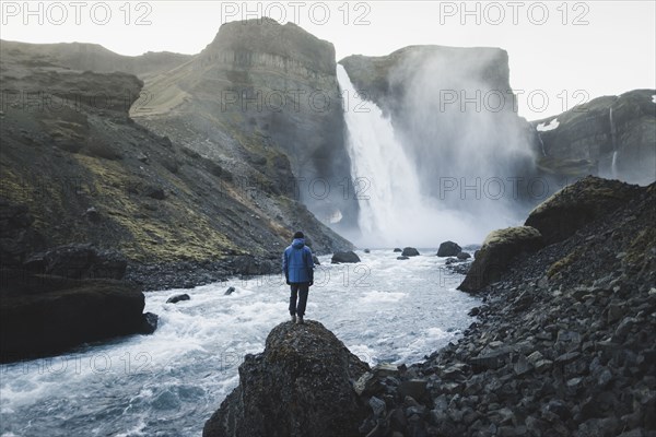 Hiker by Haifoss waterfall in Iceland