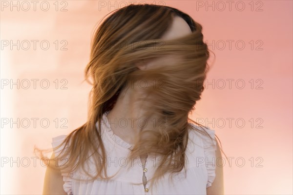 Young woman tossing her hair