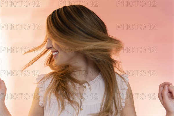 Young woman tossing her hair