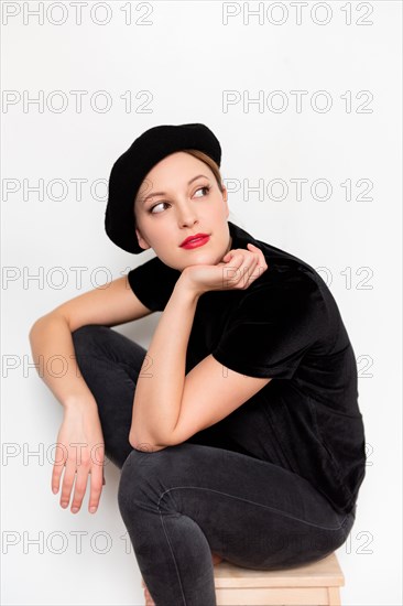 Young woman wearing beret and red lipstick