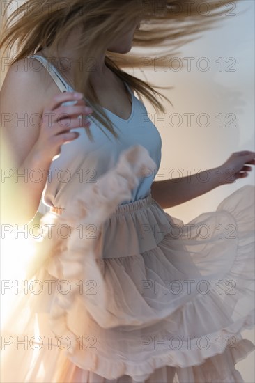 Young woman tossing her head while dancing