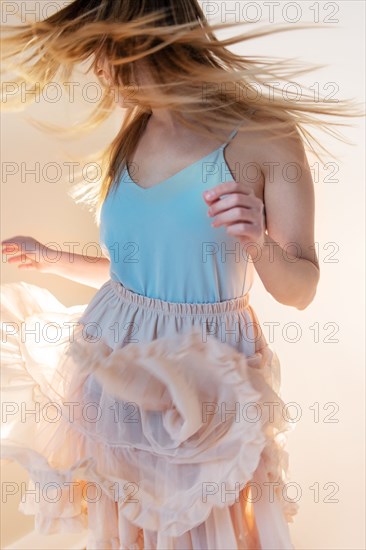 Young woman tossing her head while dancing