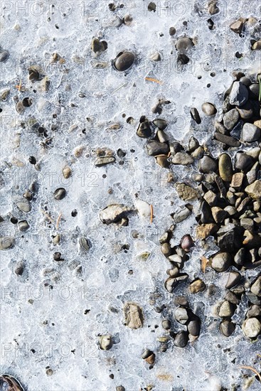 Ice over pebbles