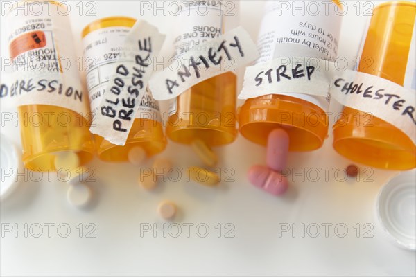 Spilled pill bottles labelled with ailments