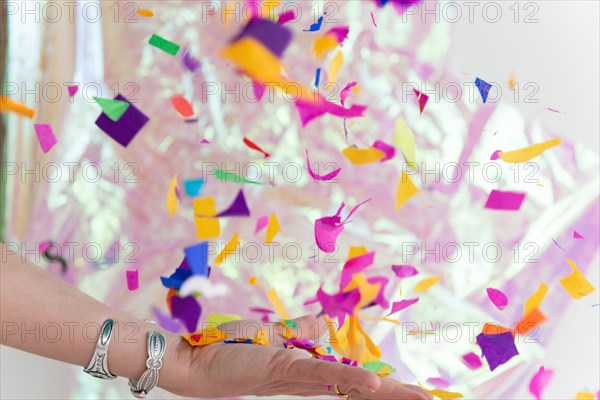 Woman's hand throwing confetti