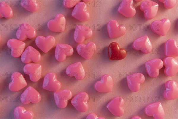 Pink and one red heart shaped candy