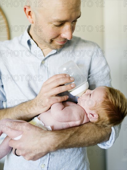 Man feeding his baby son