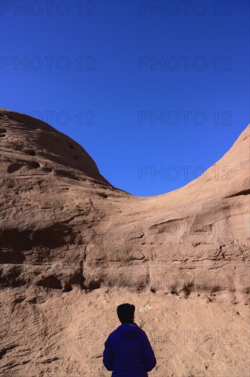 Silhouette of woman by rock formation in Monument Valley, Arizona, USA