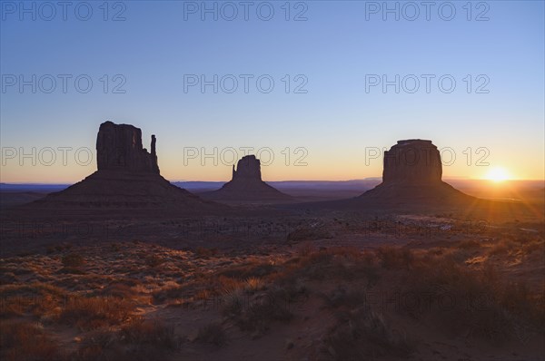Silhouettes of rock formations at sunset in Monument Valley, Arizona, USA