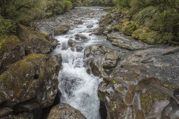 River over rocks in Milford Sound, New Zealand