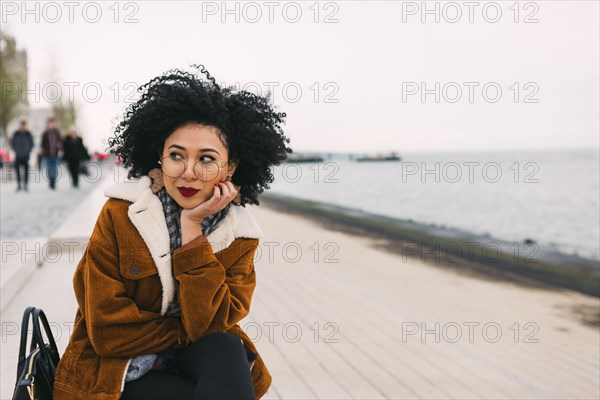 Young woman on waterfront in Lisbon, Portugal